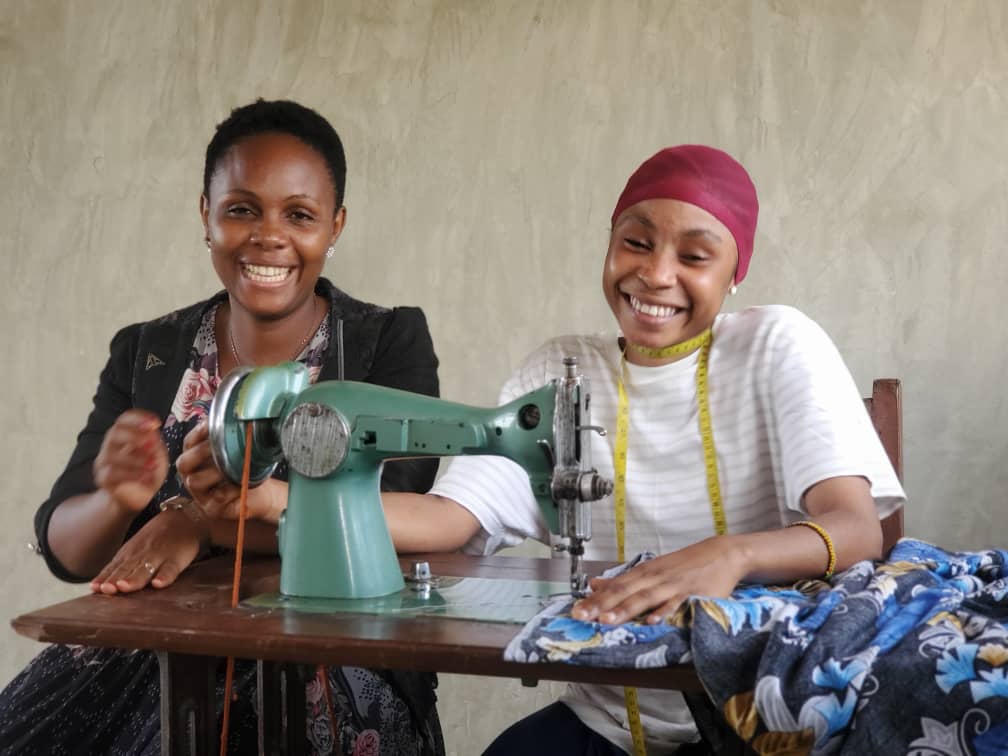 Young mothers learning tailoring skills